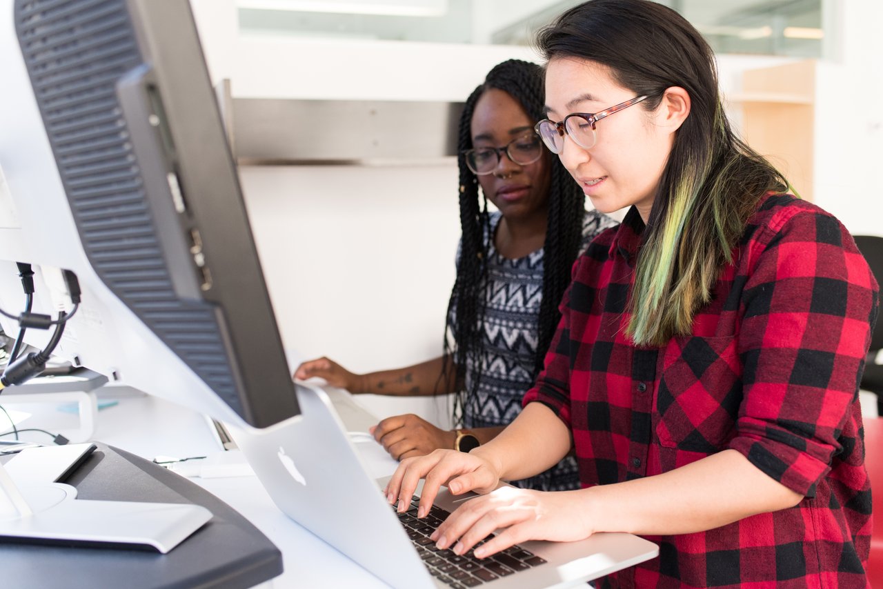 Staff working on PC for ISO documentation numbering