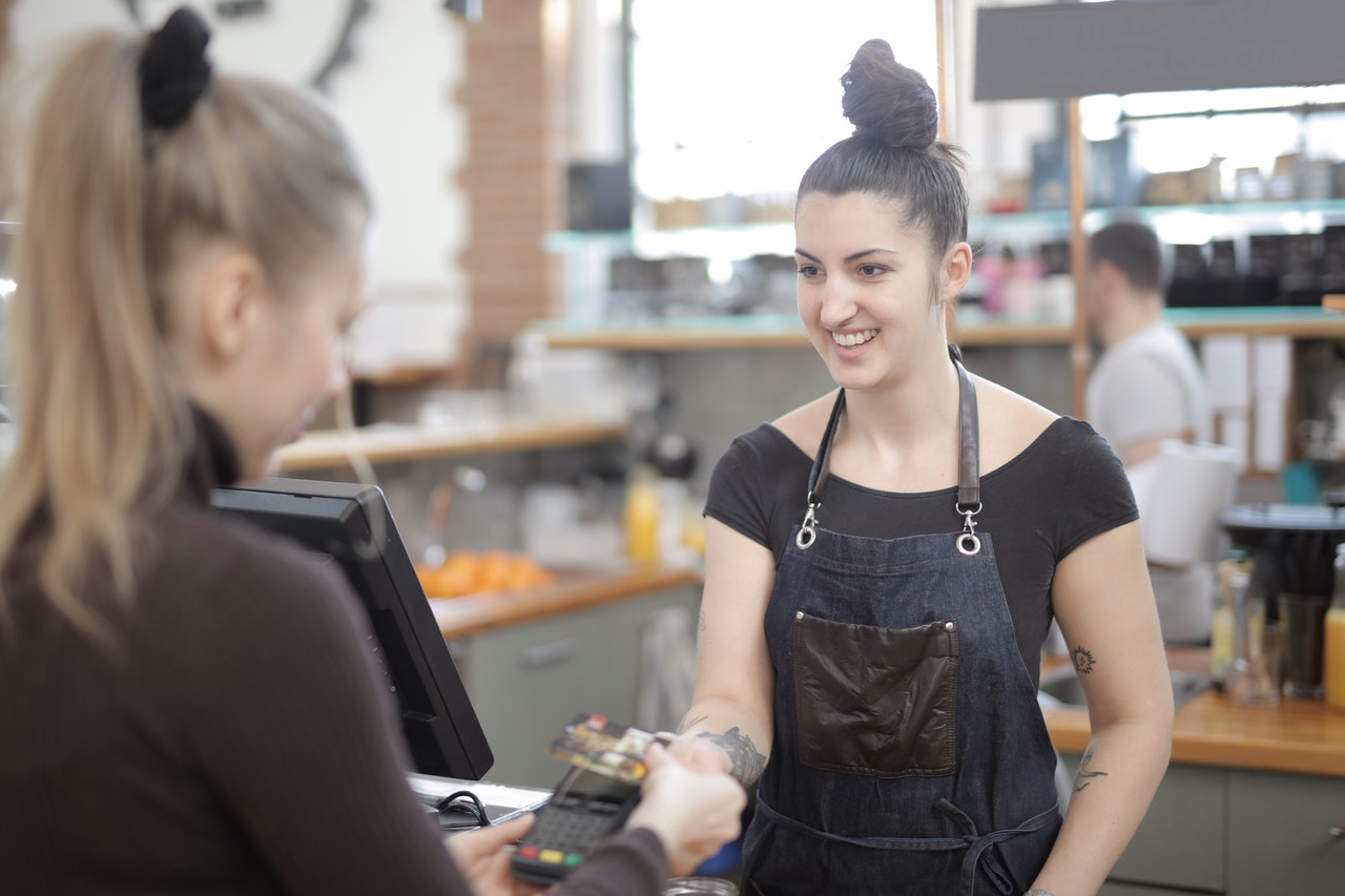 Woman showing customer satisfaction at the retail counter